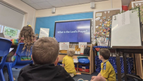 Thousands of school children join in saying the Lord's Prayer
