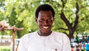 Pastor Laminu holding his Koma Bible at its launch in Ghana in 2024