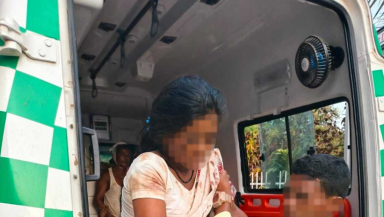 A victim from the attack on Christians in Sadrapal is helped out of an ambulance.