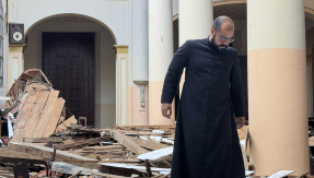 Priest investigating church ruins in Venezuela