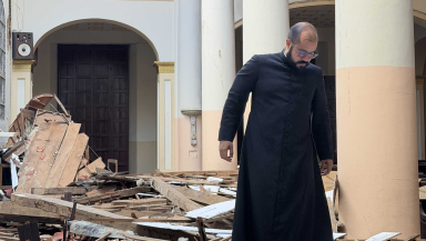 Priest investigating church ruins in Venezuela
