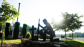 City sued over war memorial with Christian cross statue