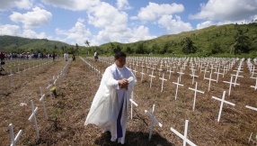 Church bells toll as Philippines remembers thousands killed a year after typhoon Haiyan
