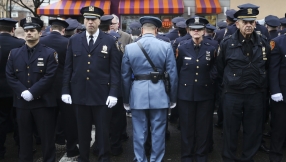 Hundreds of police turn backs on NYC mayor during slain officer\'s funeral