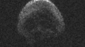Dark dead comet looking like skull with empty eye sockets passes close to Earth on Halloween night
